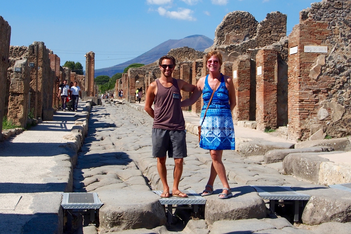 The walking the streets of Pompeii, Mount Vesuvius in the background
